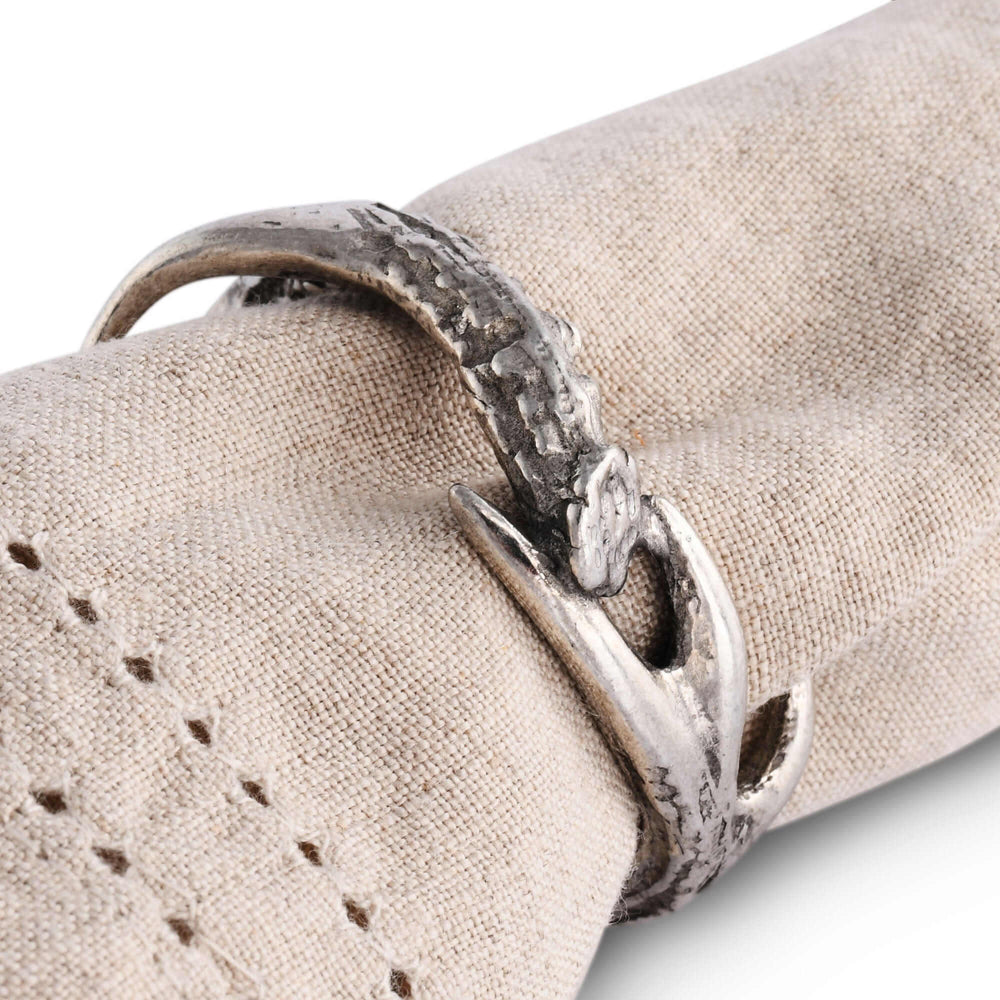 Silver napkin ring on a beige fabric surface