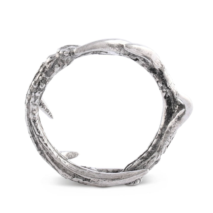 Silver napkin ring with a textured design on a white background
