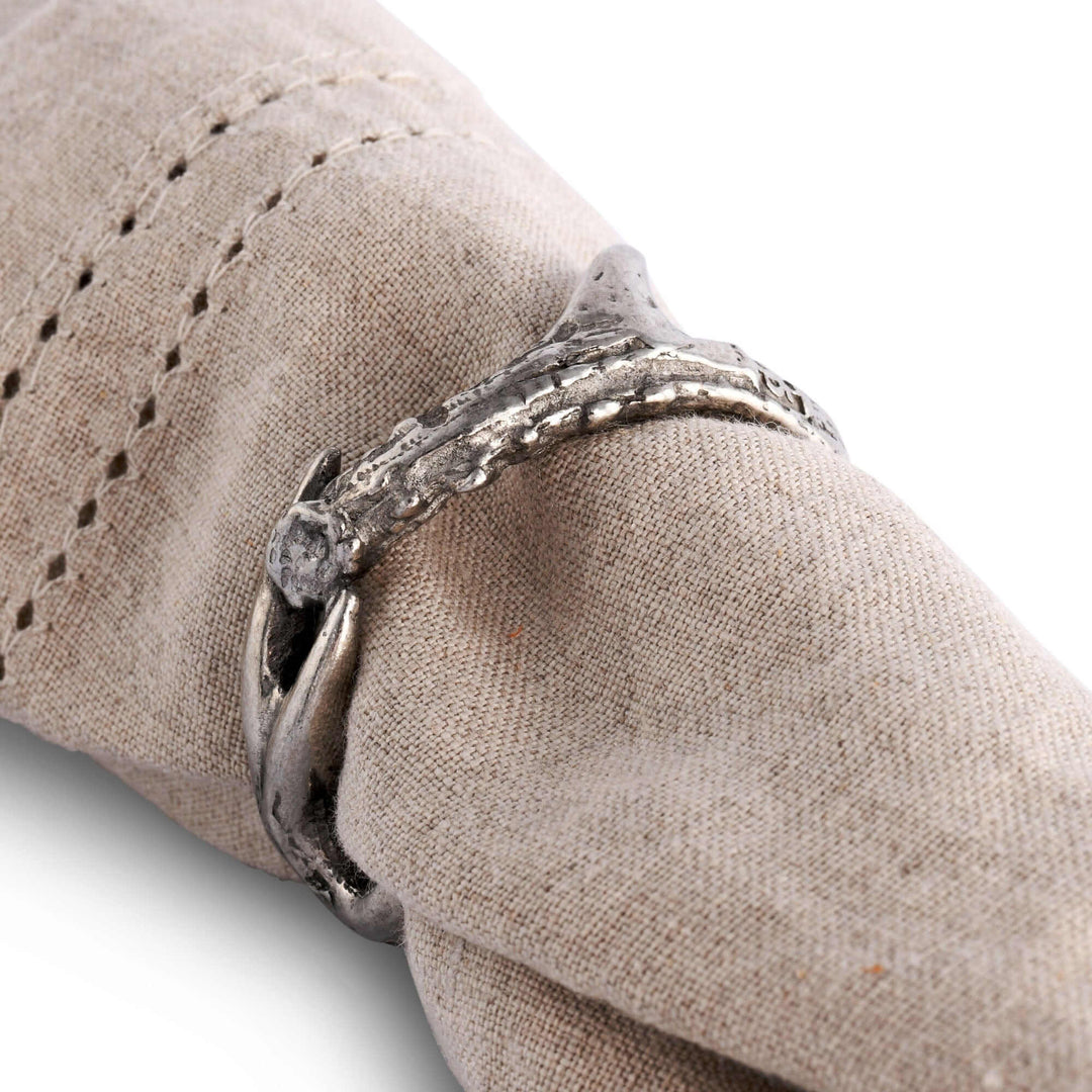 Silver napkin ring on a beige fabric surface