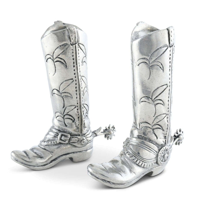 Silver cowboy boot-shaped jewelry on a white background