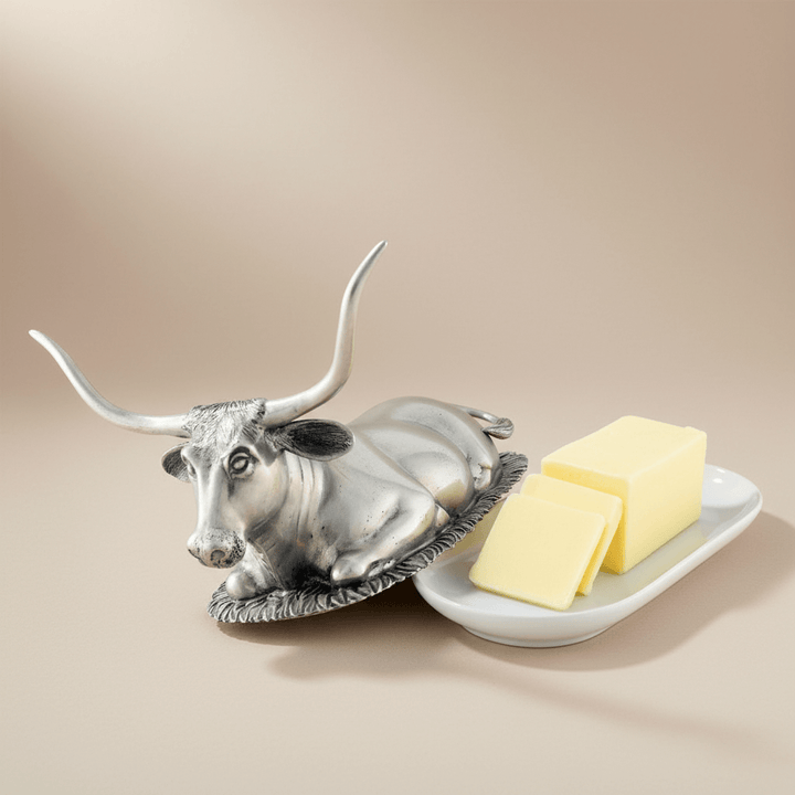 Butter dish shaped like a bull with butter on a white background