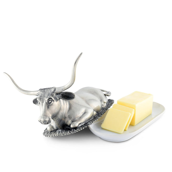 Butter dish shaped like a bull with butter on a white background