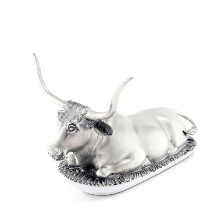 Silver bull-shaped butter dish on a white background