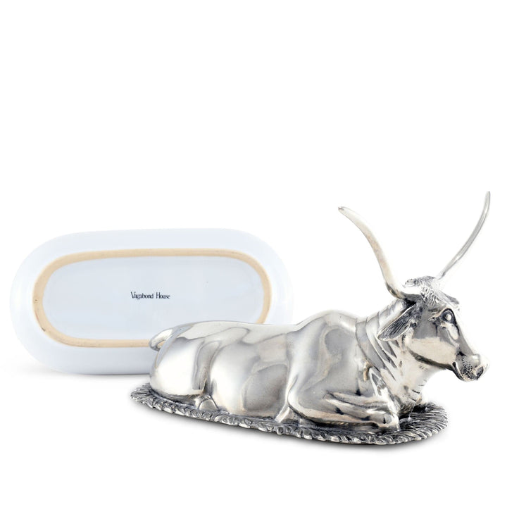 Silver bull figurine with 'Vagabond House' branding on a white background