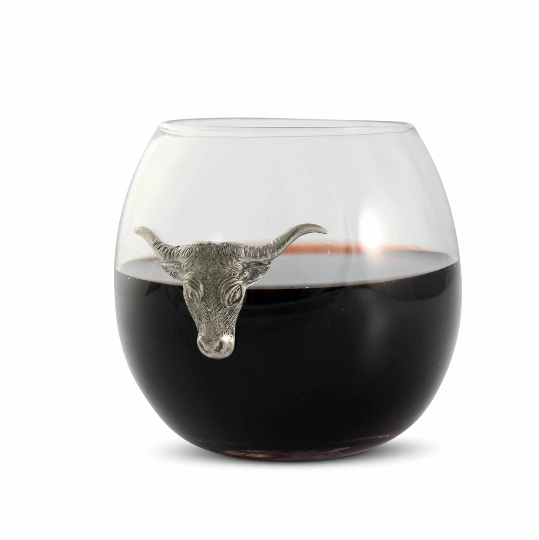 Wine glass with a metal bull head on a white background