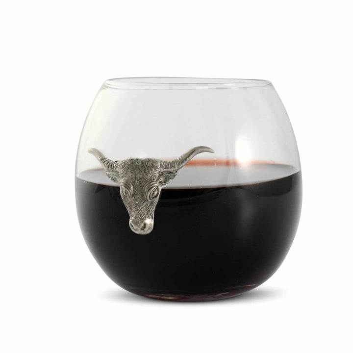 Wine glass with a metal bull head on a white background