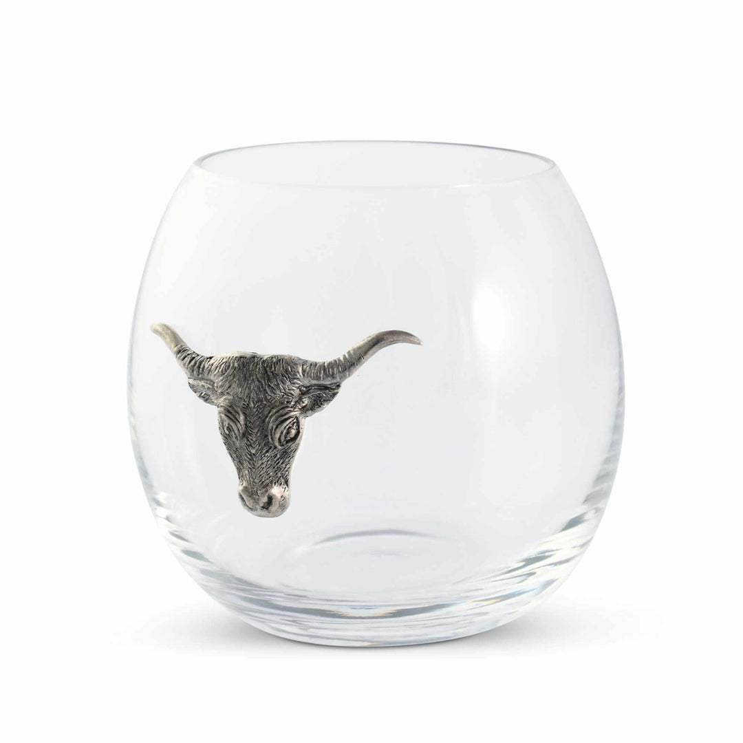 Clear glass tumbler with a metallic bull head design on a white background