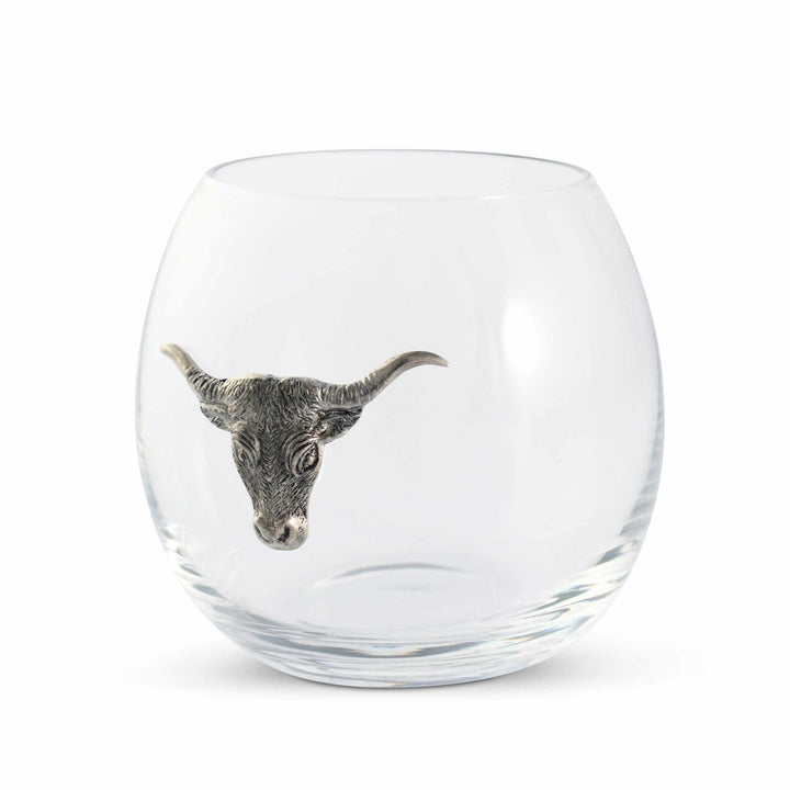Clear glass tumbler with a metallic bull head design on a white background