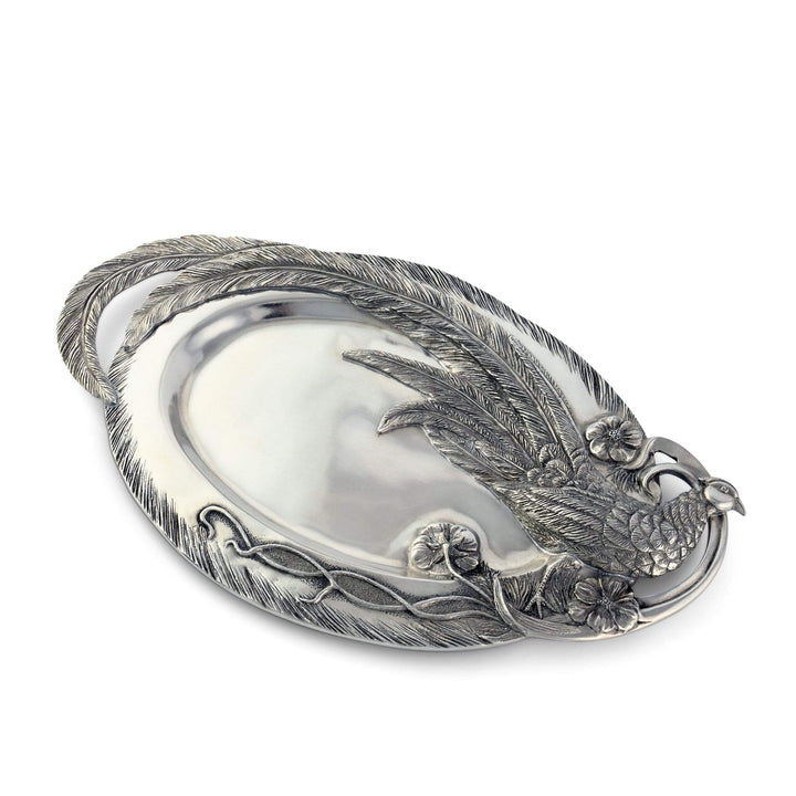Decorative silver platter with feather and floral designs on a white background