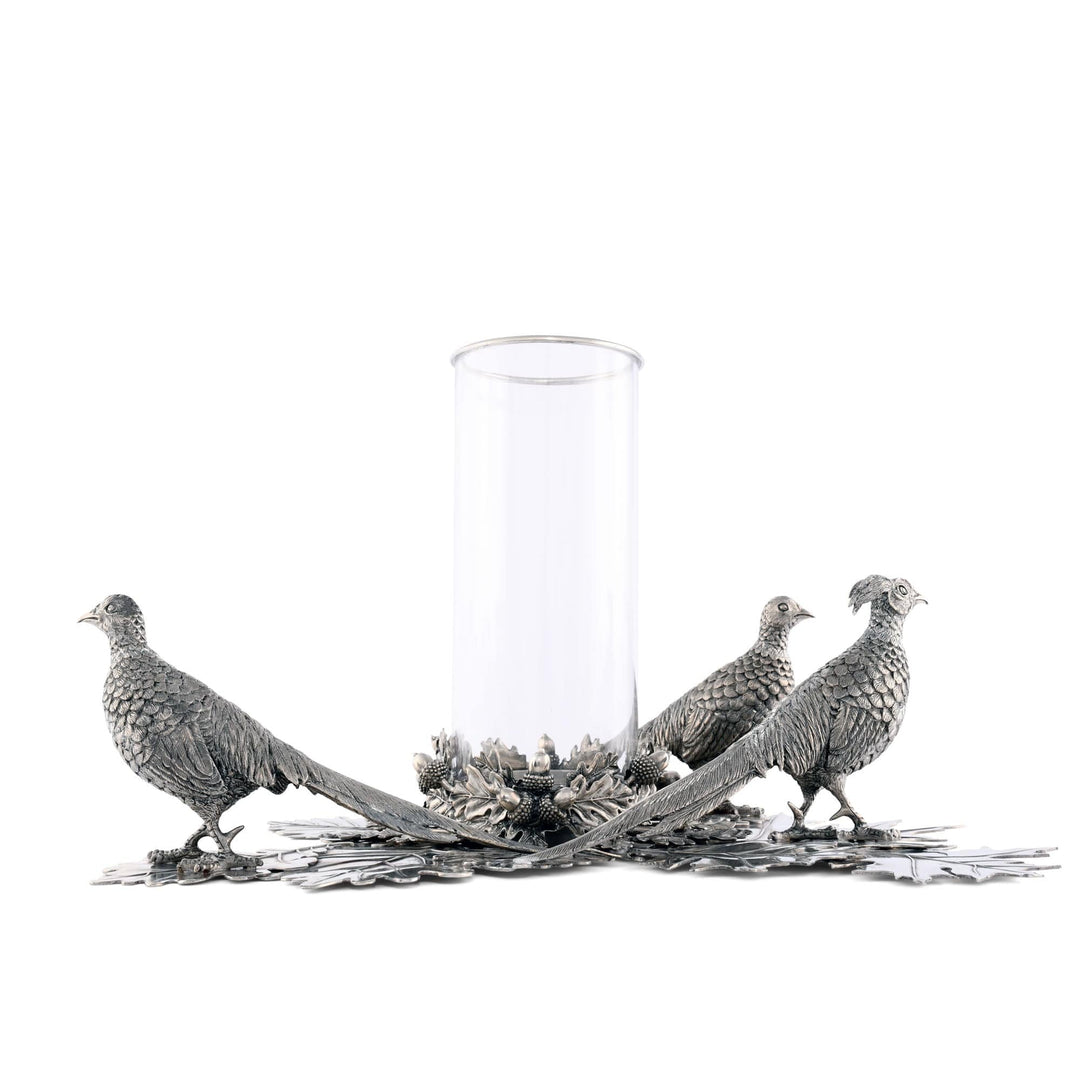 Decorative glass candle holder with silver pheasant sculptures on a white background