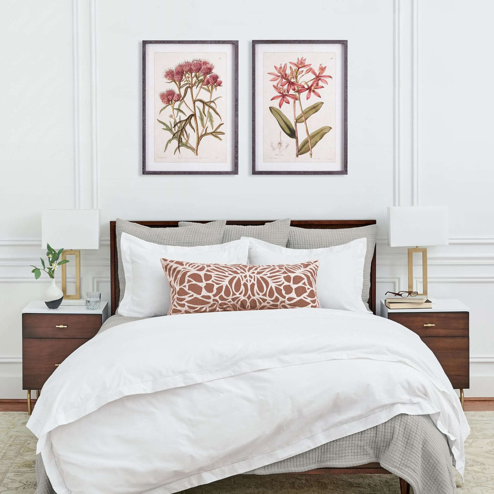 Pink Vintage Botanical Floral Prints on a wall above a bed