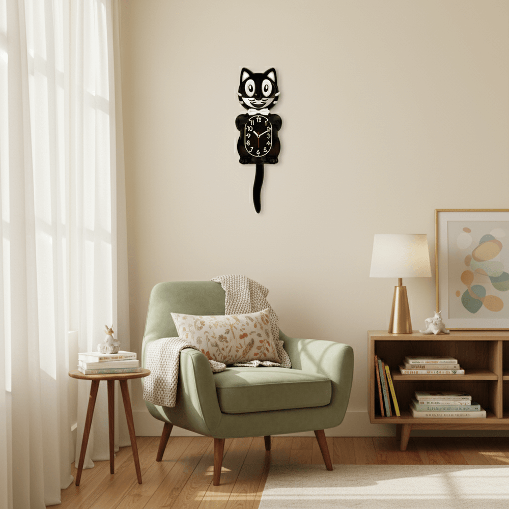 Wall clock shaped like a cat on a wall above a green armchair in a living room.