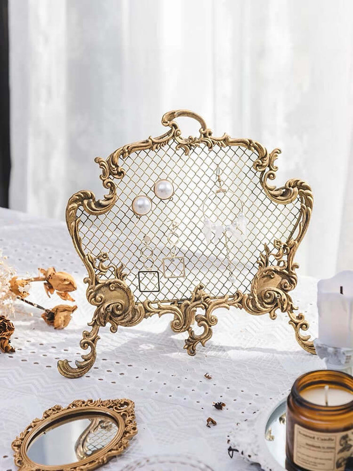 Elegant Rococo jewelry display in gold showcasing pearl earrings, blending vintage charm with modern functionality.