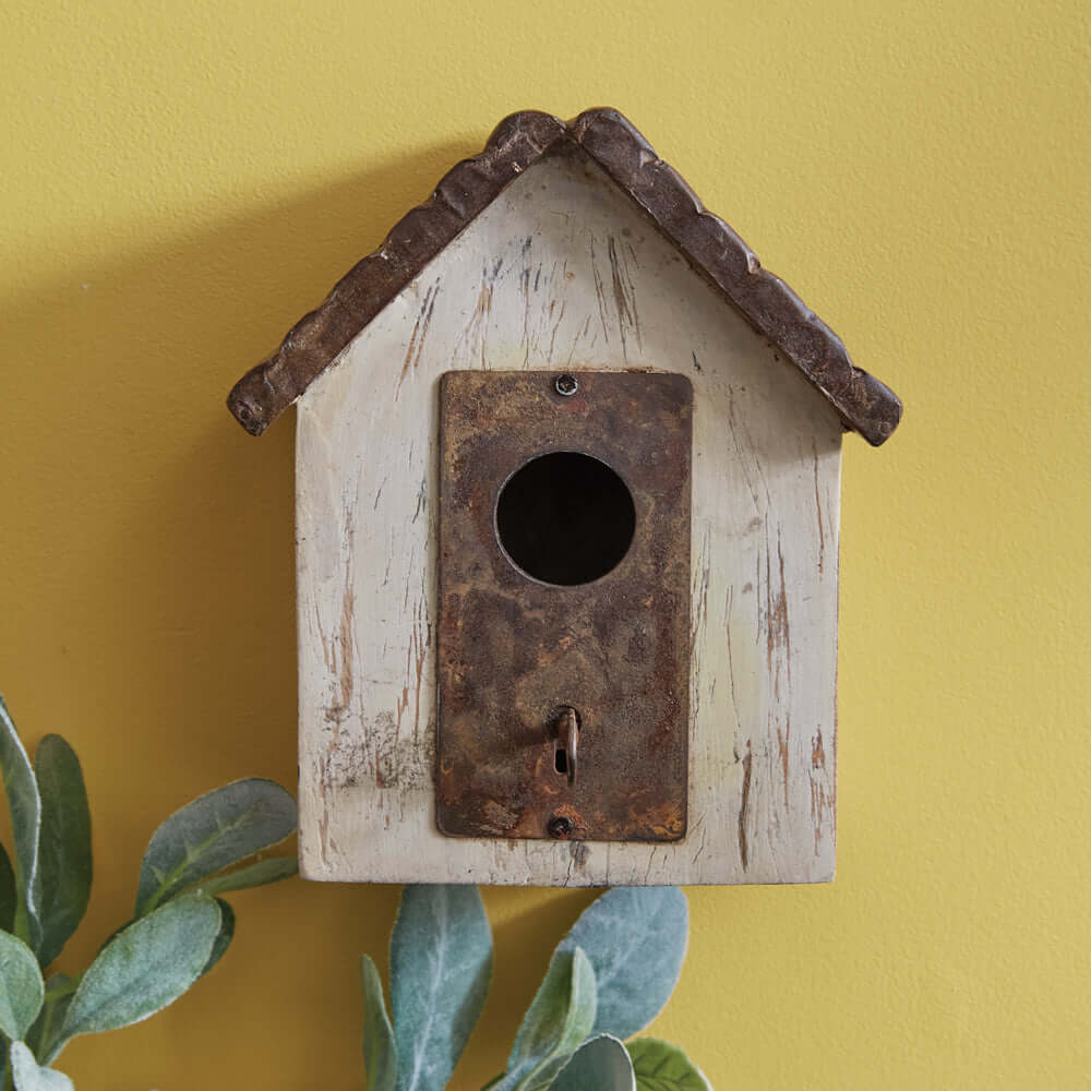 Rustic farmhouse wooden birdhouse with distressed wood and metal roof, ideal vintage garden décor.