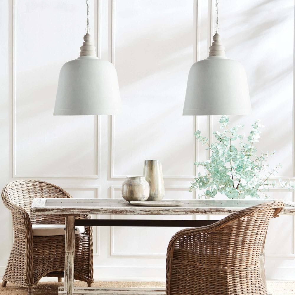 Rustic White Pendant Light for Farmhouse Kitchens hung over a table and chairs