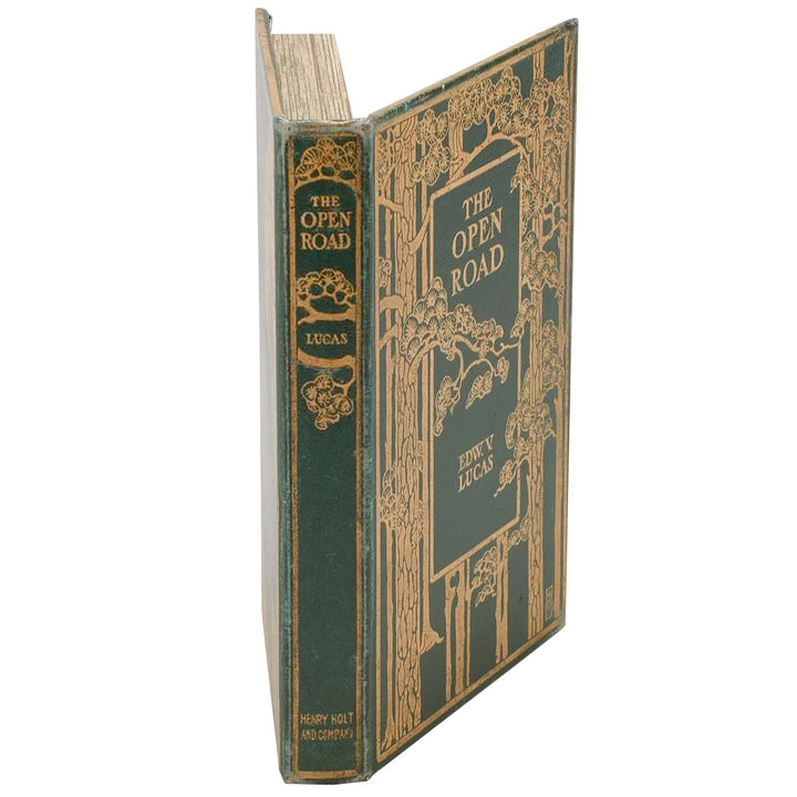 Vintage book titled 'The Open Road' with decorative green and gold binding on a white background