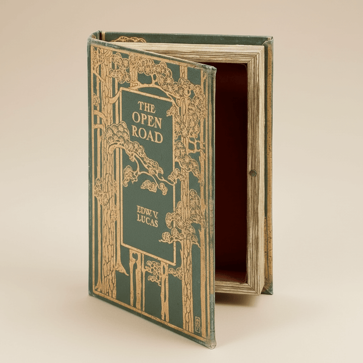 Vintage book titled 'The Open Road' with decorative cover on a beige background