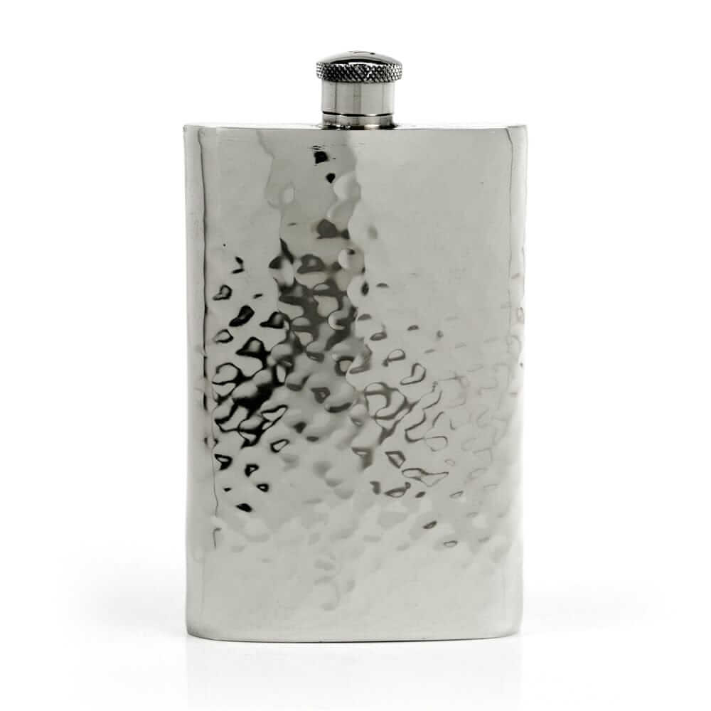 Pewter hip flask with textured surface on a white background