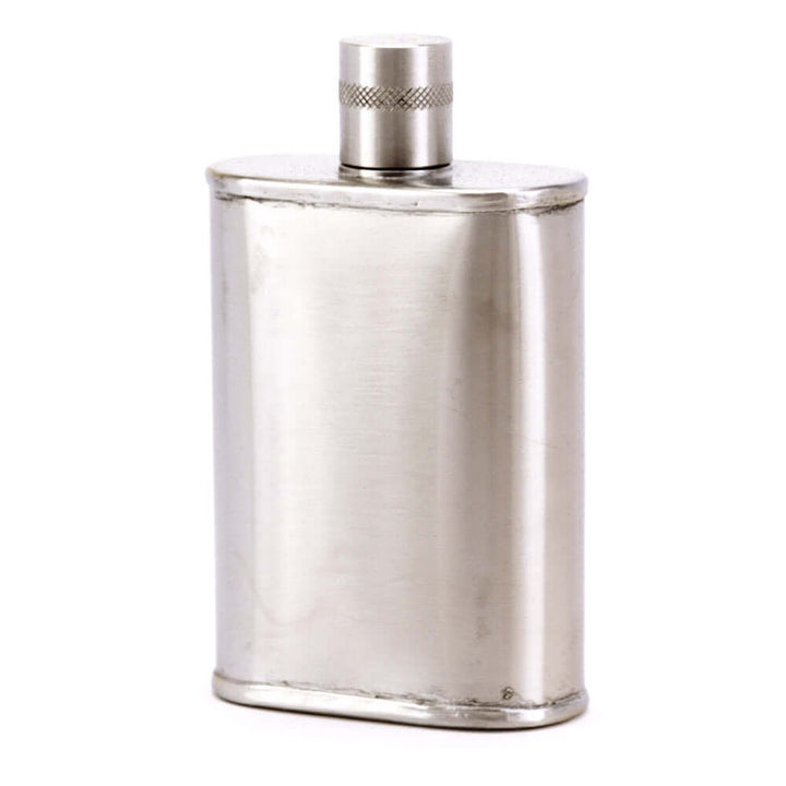 Silver flask with a textured cap on a white background