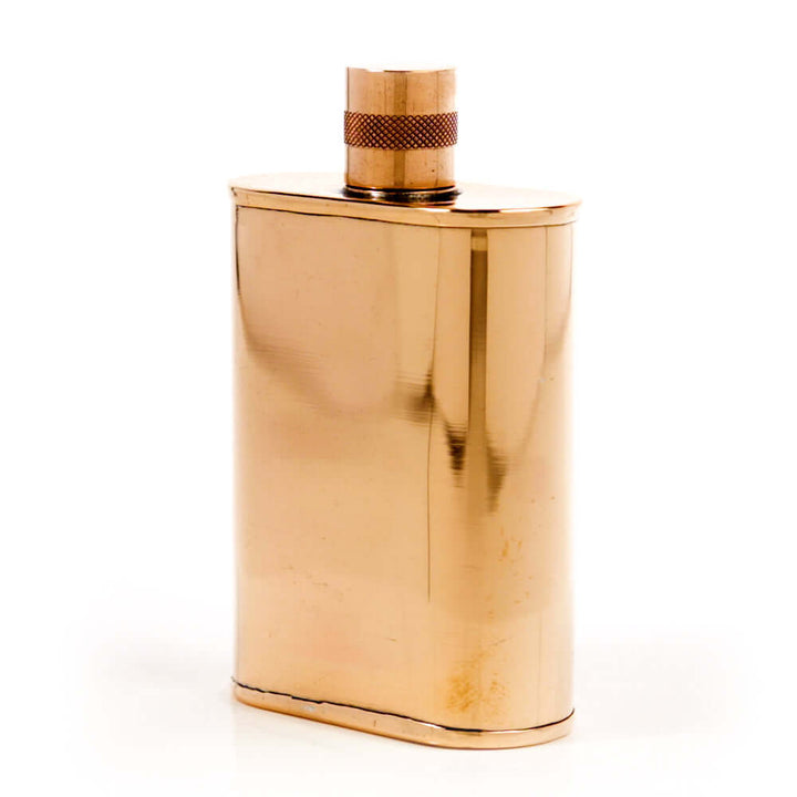 Gold flask with cap on a white background