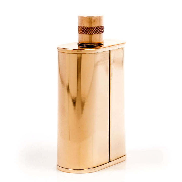 Copper flask with a textured cap on a white background