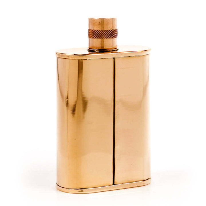 Copper flask with a textured cap on a white background