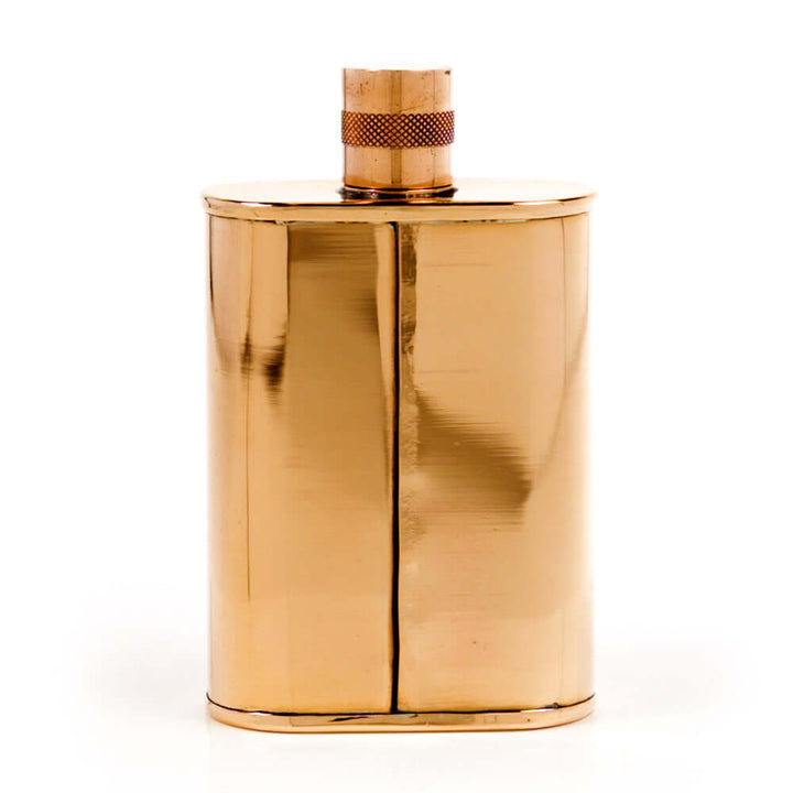 Copper metallic flask with cap on a white background
