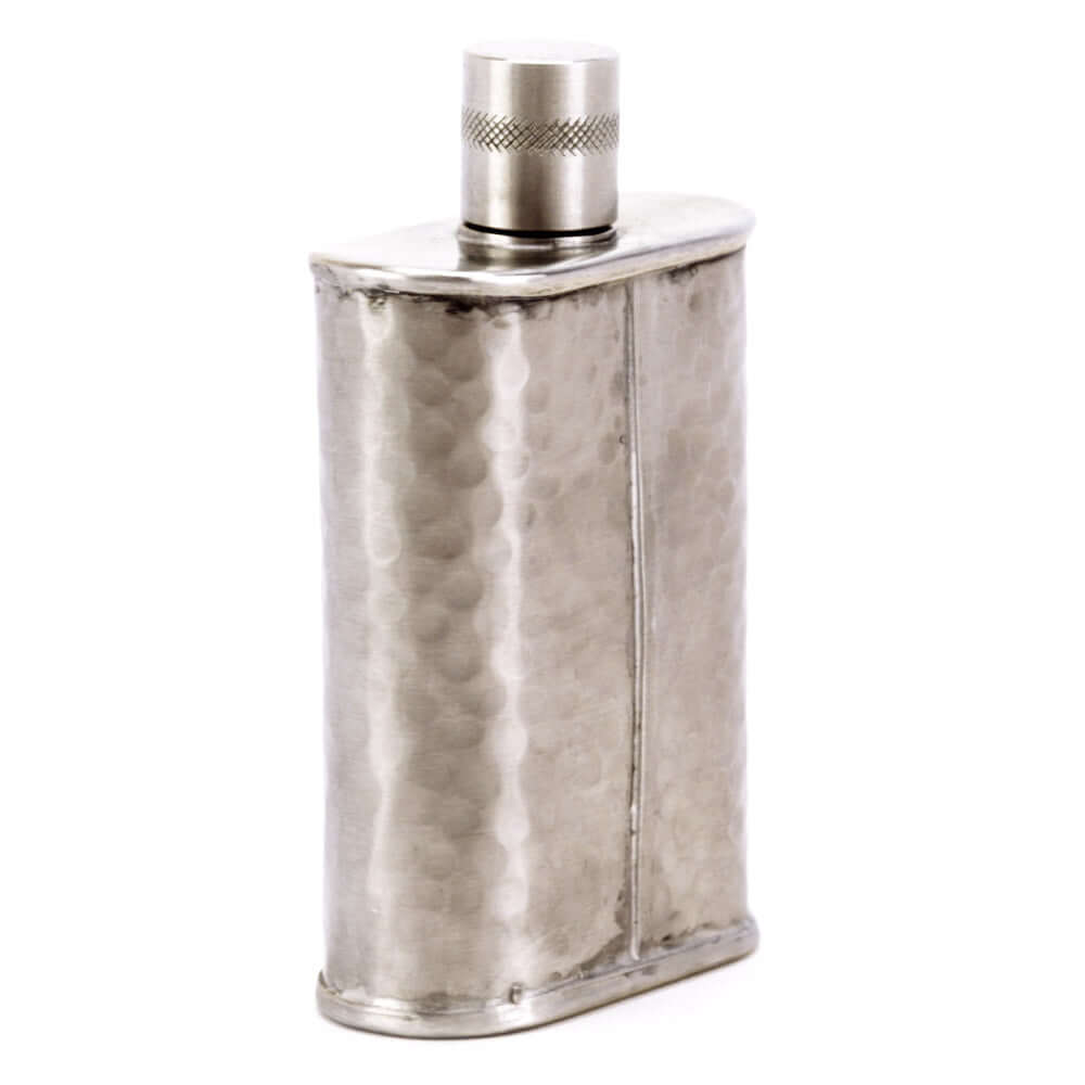 Silver flask with textured surface and metallic cap on a white background