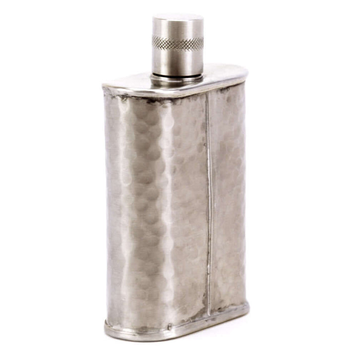 Silver flask with textured surface and metallic cap on a white background