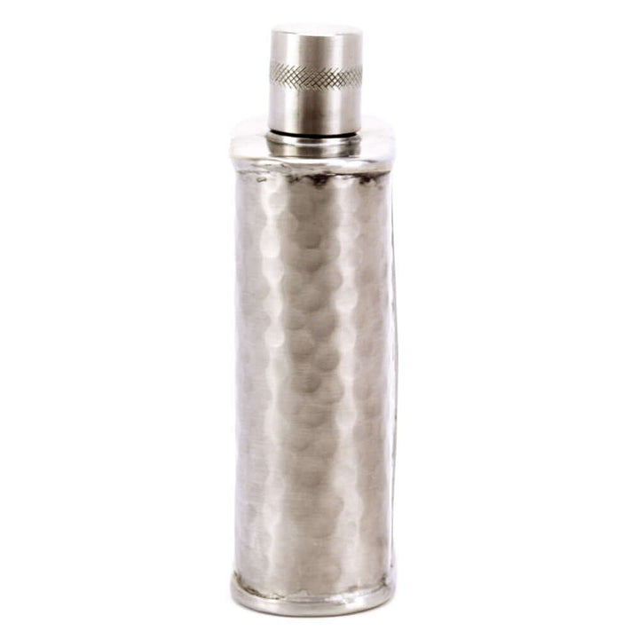 Silver metallic flask with textured design on a white background