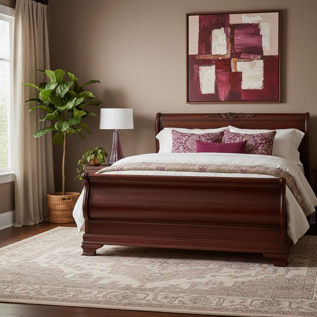 Bedroom with wooden sleigh bed, lamp, and abstract painting on wall.