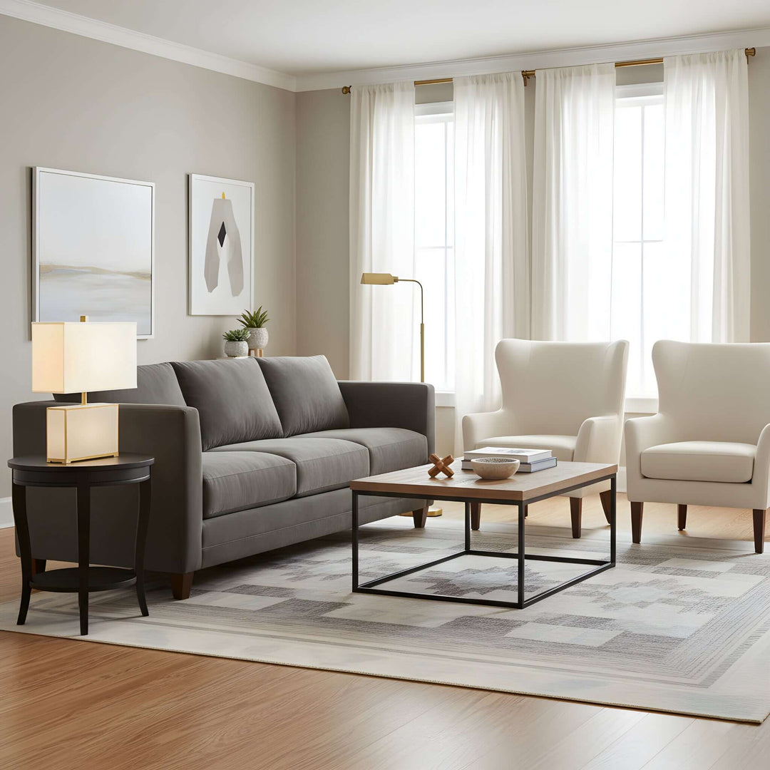 Living room with gray sofa, white chairs, and a coffee table.
