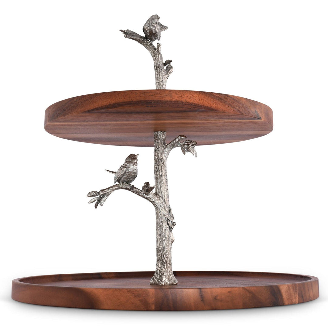 Two-tiered wooden serving tray with metal bird and branch decorations on a white background