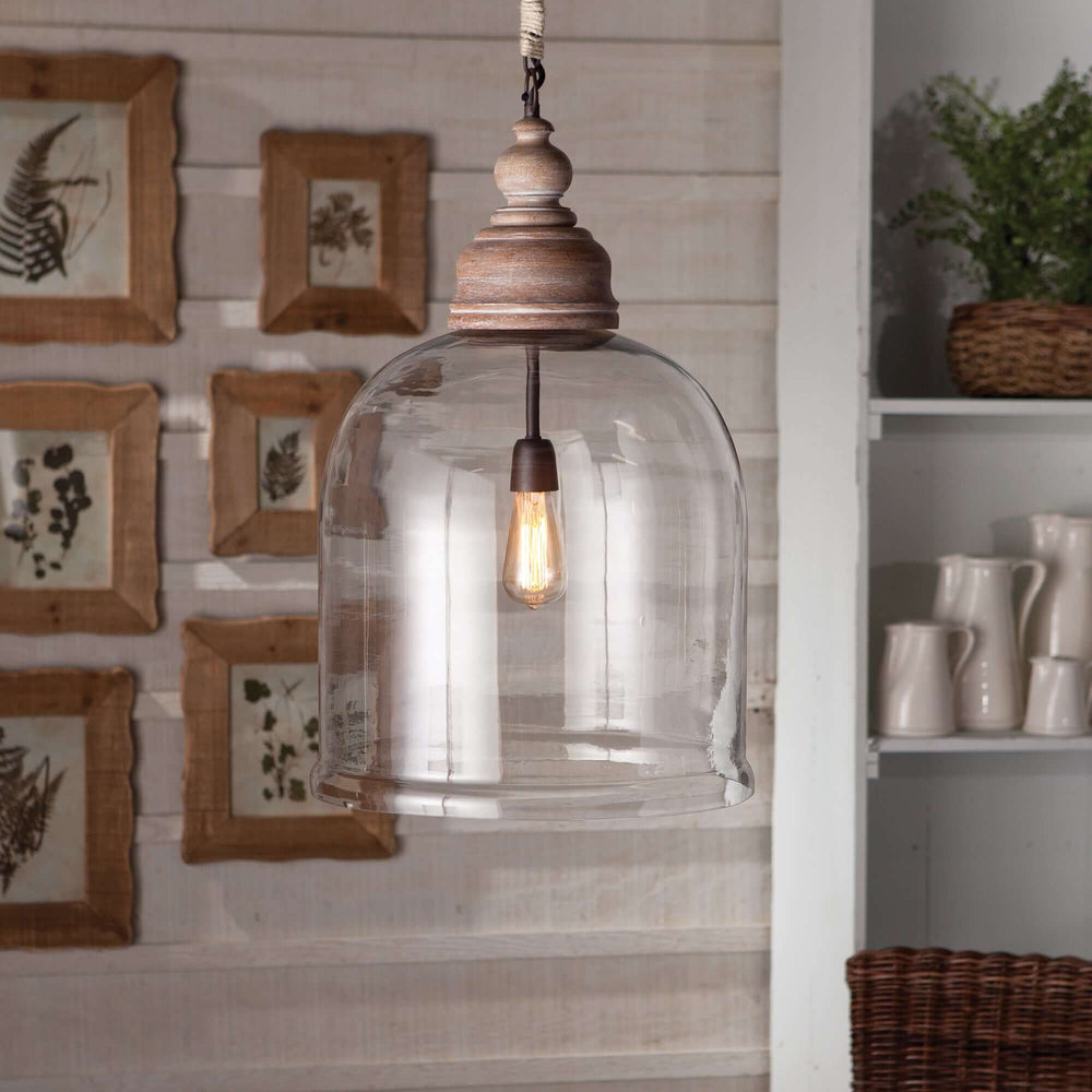 Farmhouse glass cloche pendant light with rustic wood accent, vintage style, clear shade, and warm ambiance.