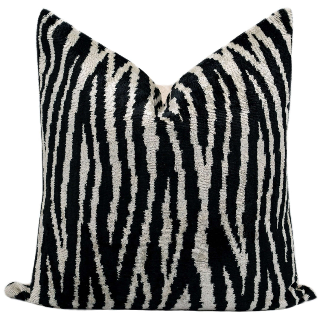 Black and white zebra patterned pillow on a white background