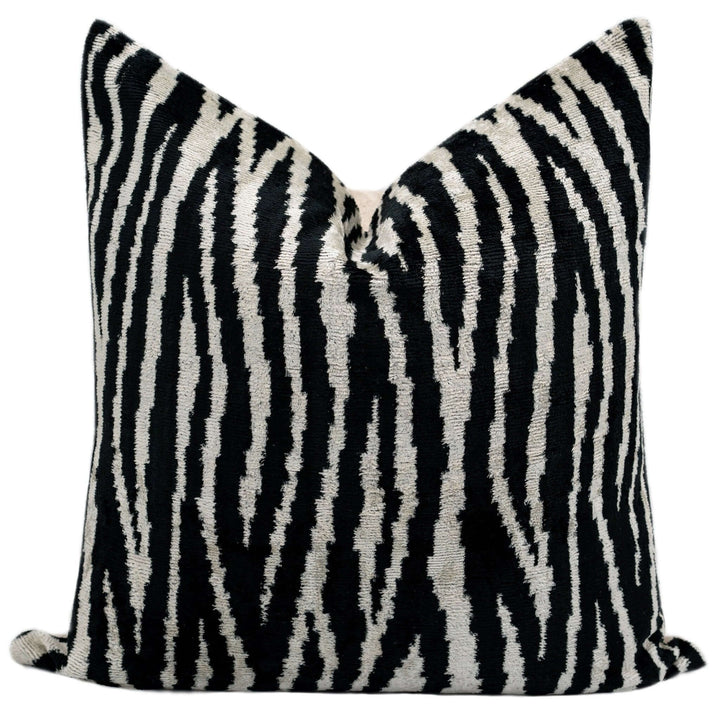 Black and white zebra patterned pillow on a white background