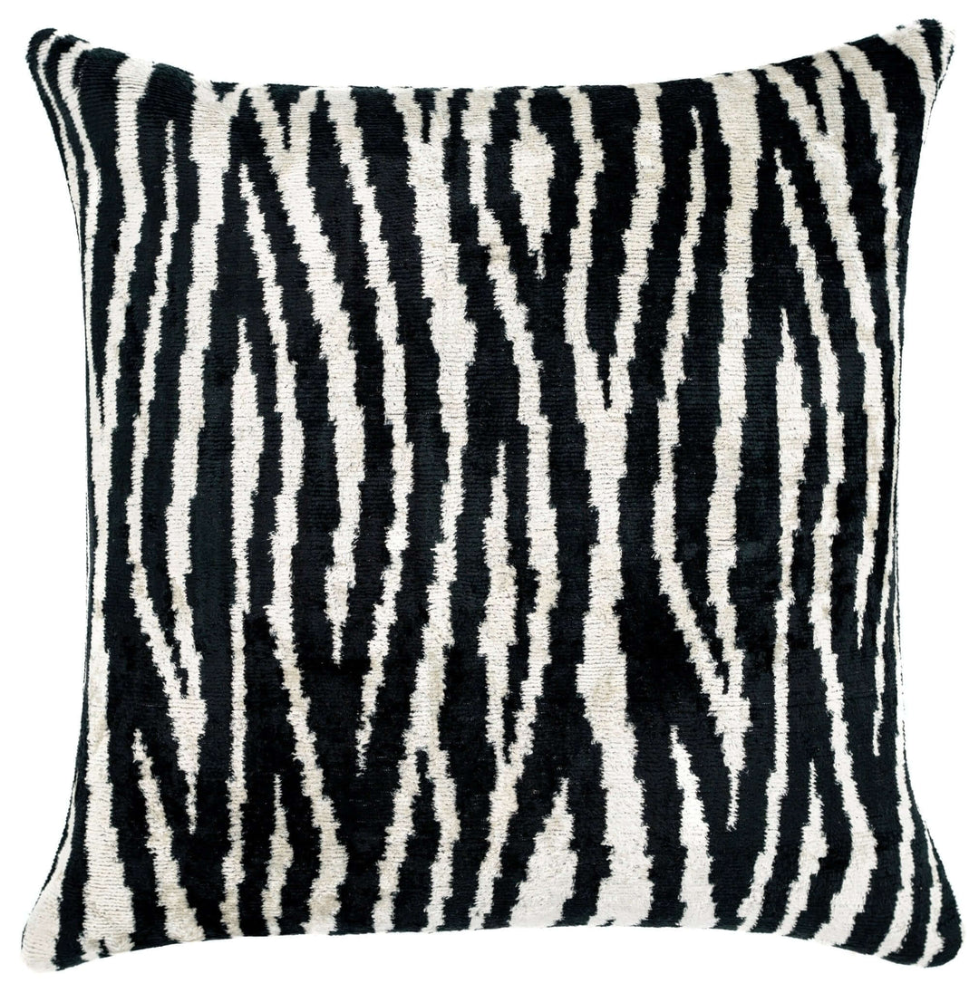 Decorative pillow with black and white zebra pattern on a plain background