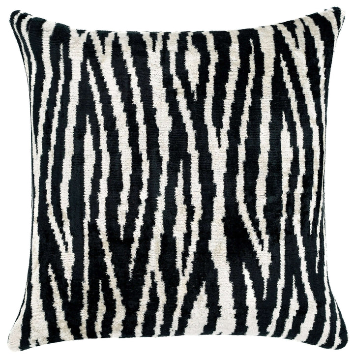 Decorative pillow with black and white zebra pattern on a plain background