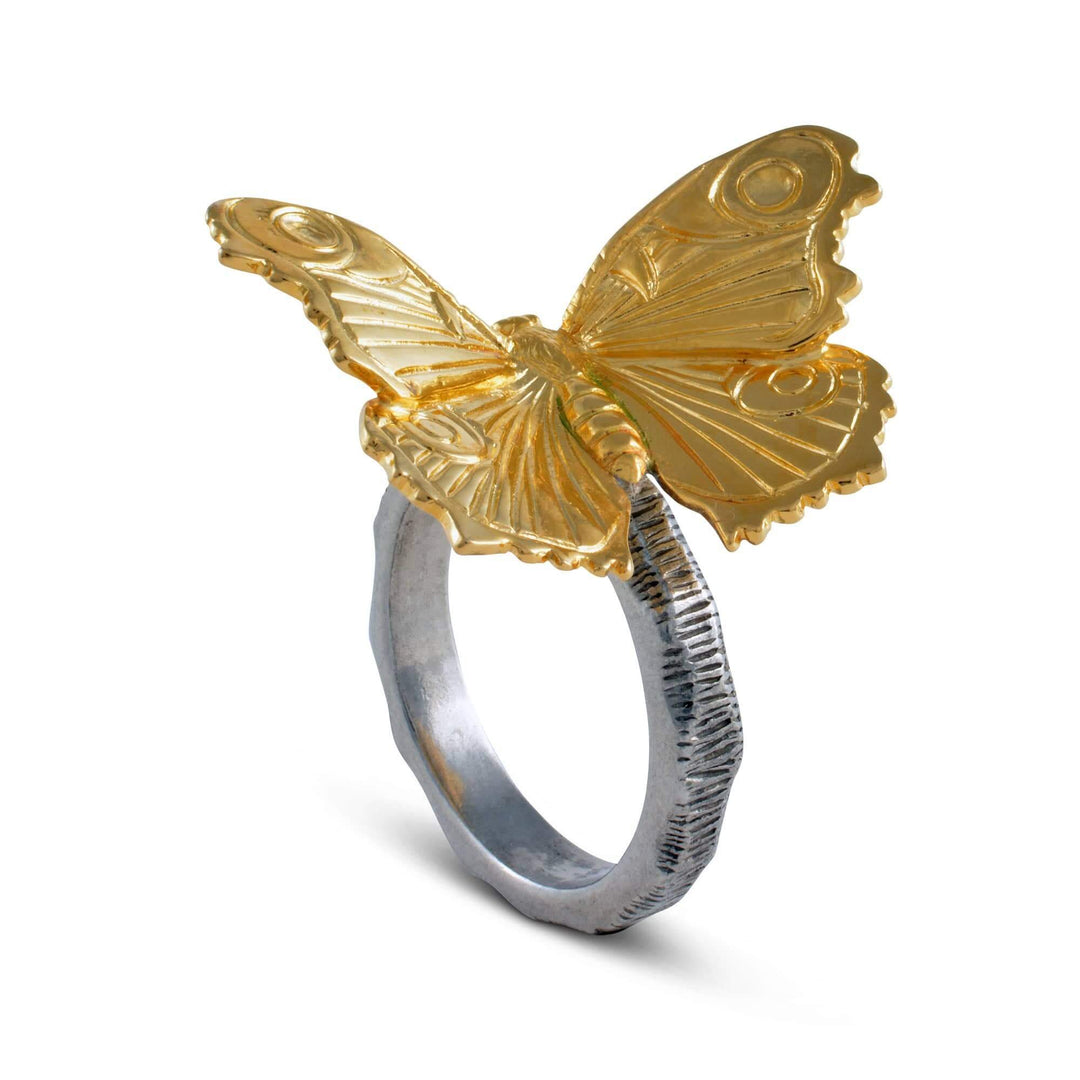 Gold butterfly ring on a white background