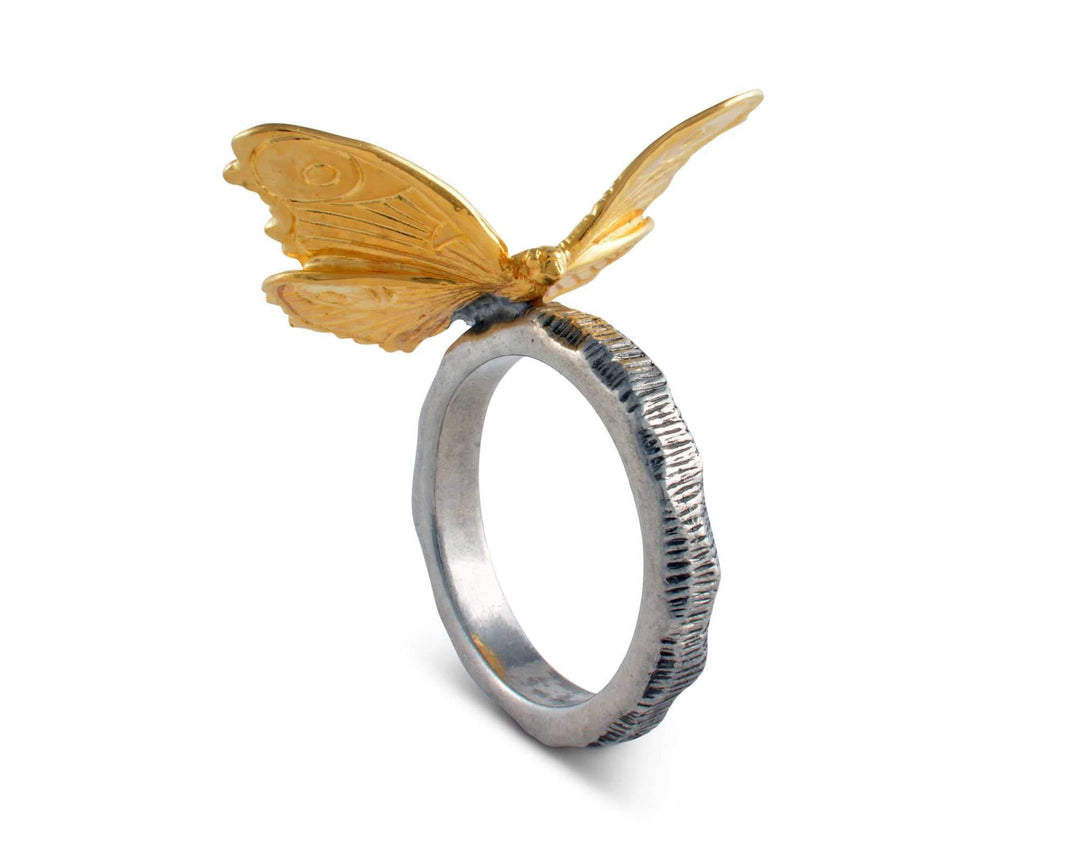 Silver napkin ring with a gold butterfly on a white background