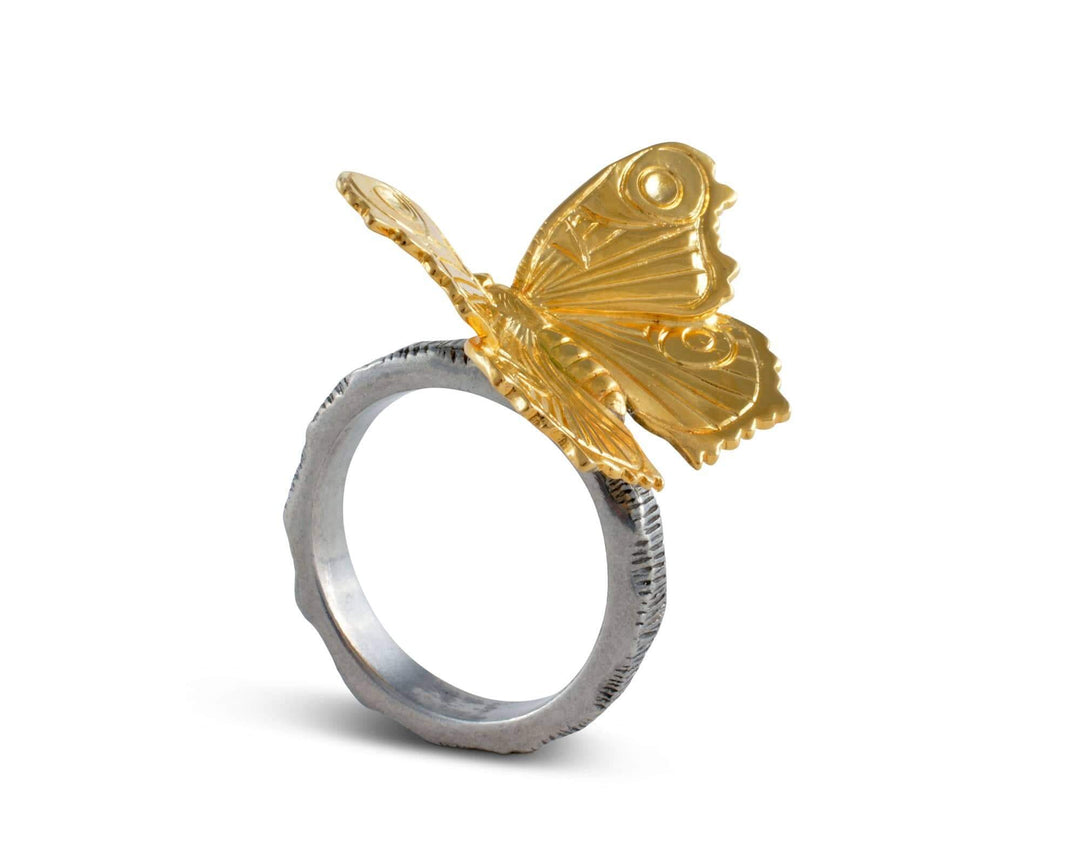 Gold butterfly ring on a white background