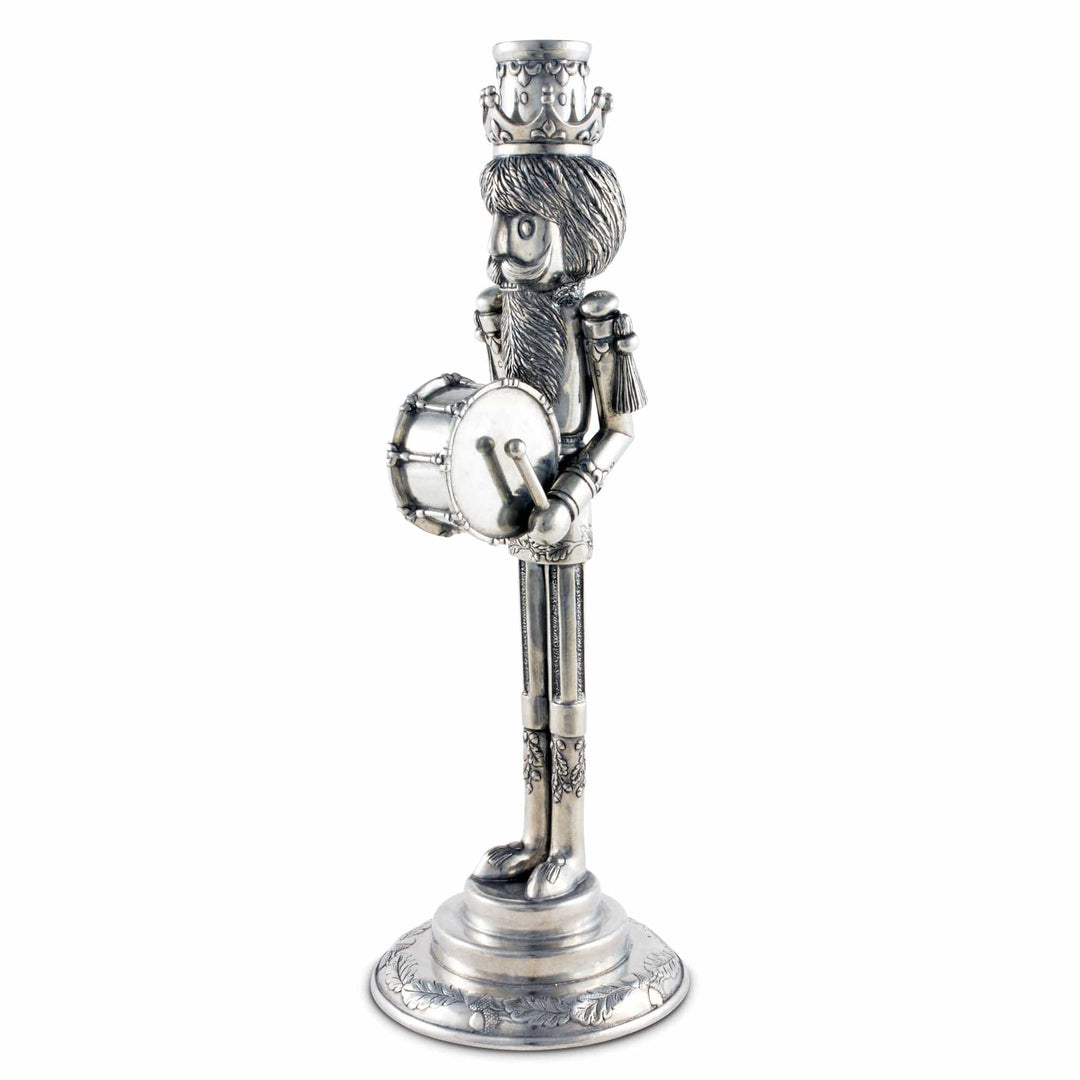 Silver figurine of a drummer with a crown on a white background
