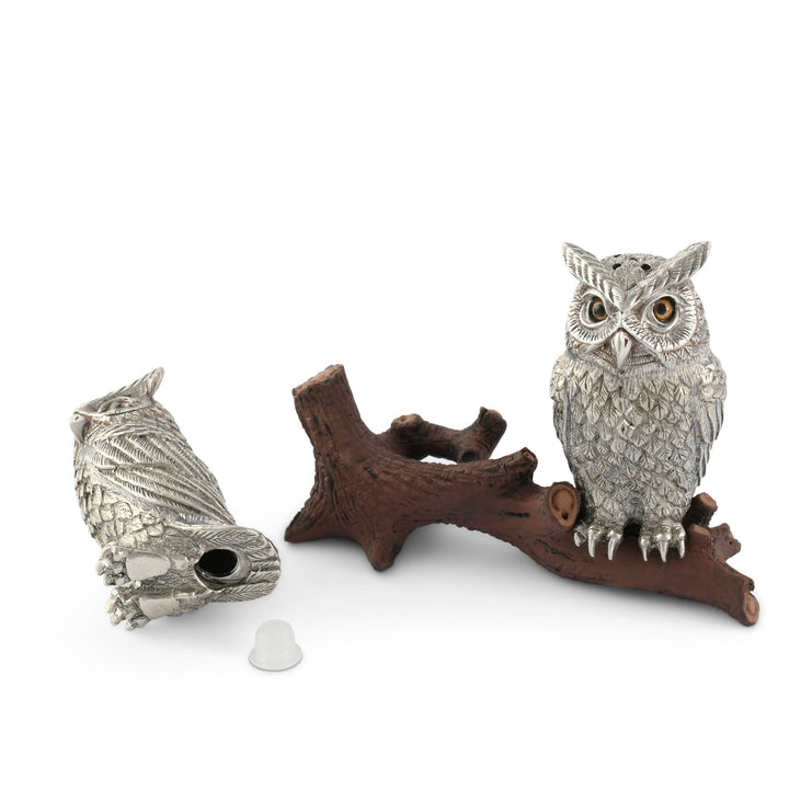 Two silver owl figurines on a white background