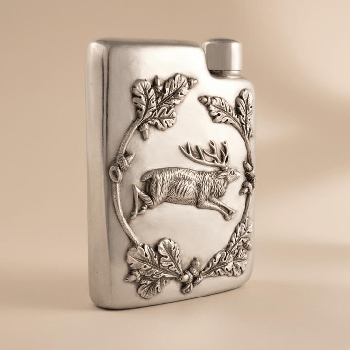 Vintage-Style Pewter Stag Flask on beige background