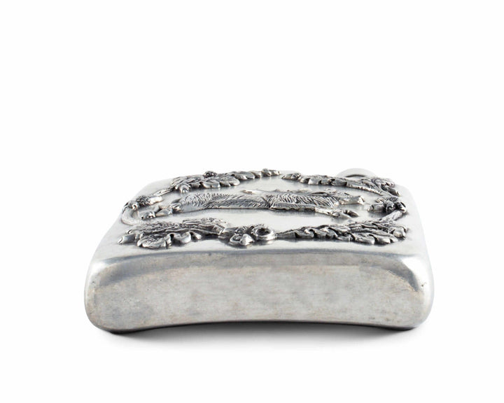 Silver decorative flask with intricate designs on a white background