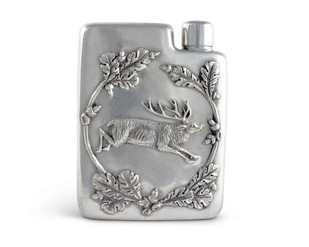 Silver flask with deer and leaf design on a white background