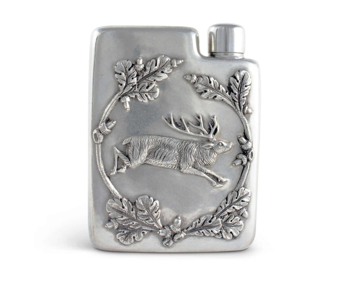 Silver flask with deer and leaf design on a white background