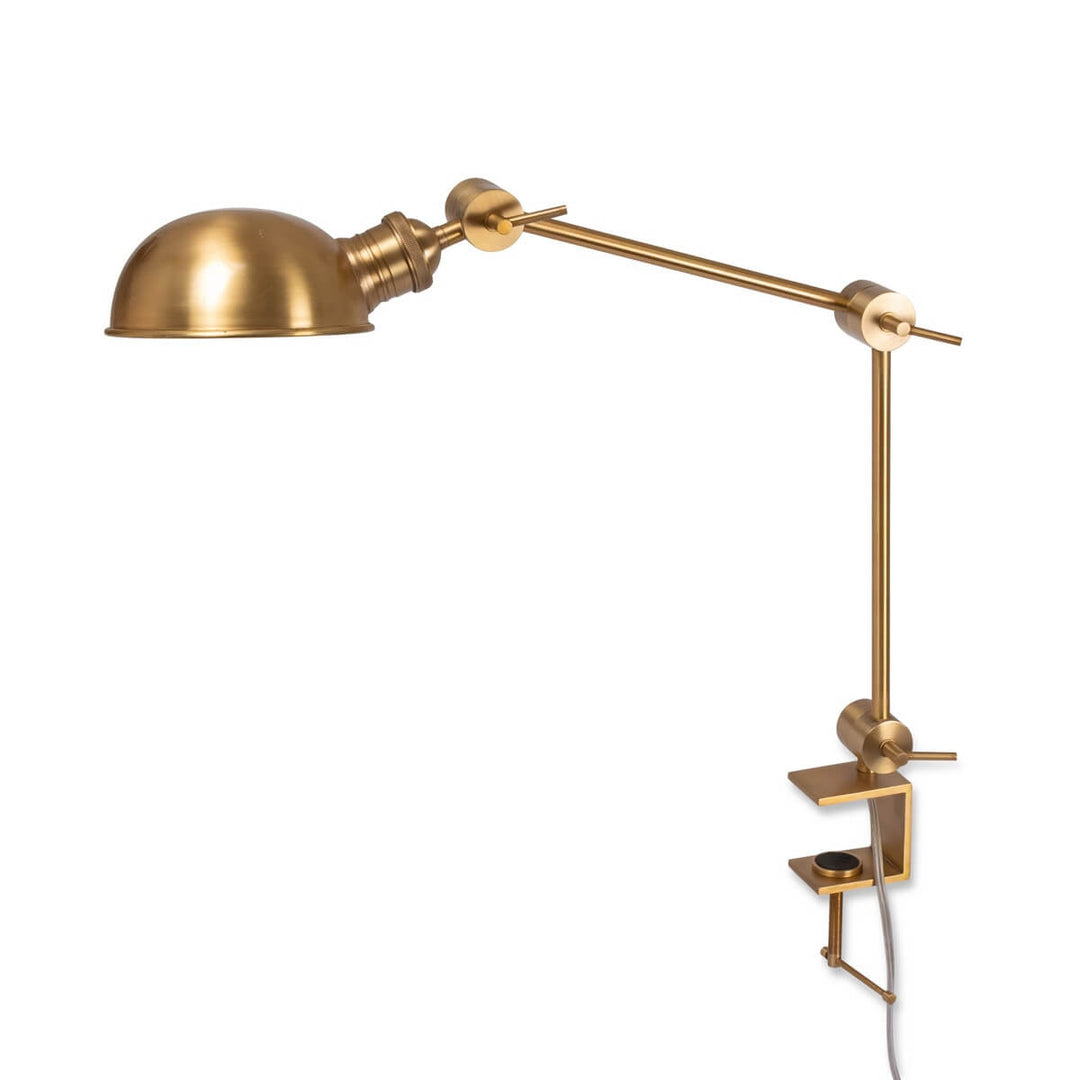 Gold wall-mounted lamp with adjustable arm on a white background