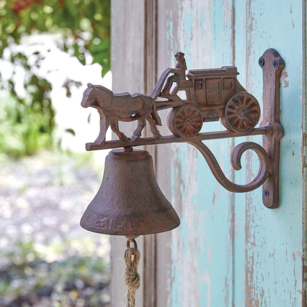 Vintage cast iron horse and stagecoach door bell, rustic wall-mounted decor for farmhouse charm.