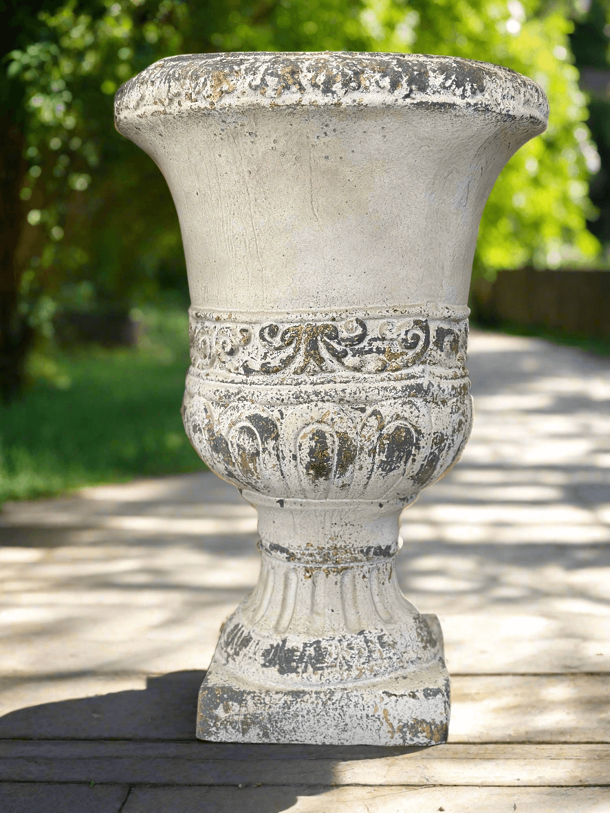 Vintage distressed decorative urn planter with ornate detailing and weathered finish for elegant home and garden décor.